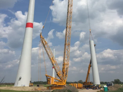 A crane assembling a wind turbine